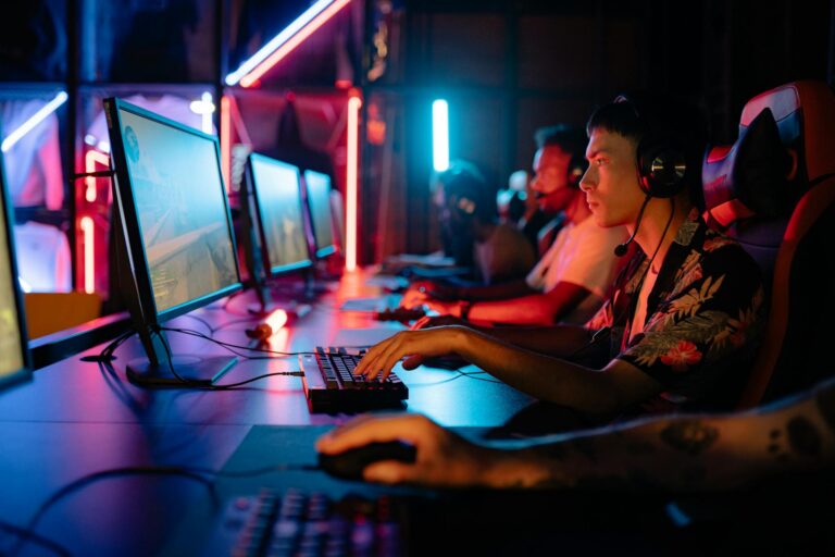 Group of gamers immersed in competitive esports at a cyber arena with neon lighting.